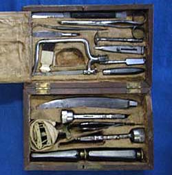 Shows a photograph of an open box of 19th century surgical instruments.